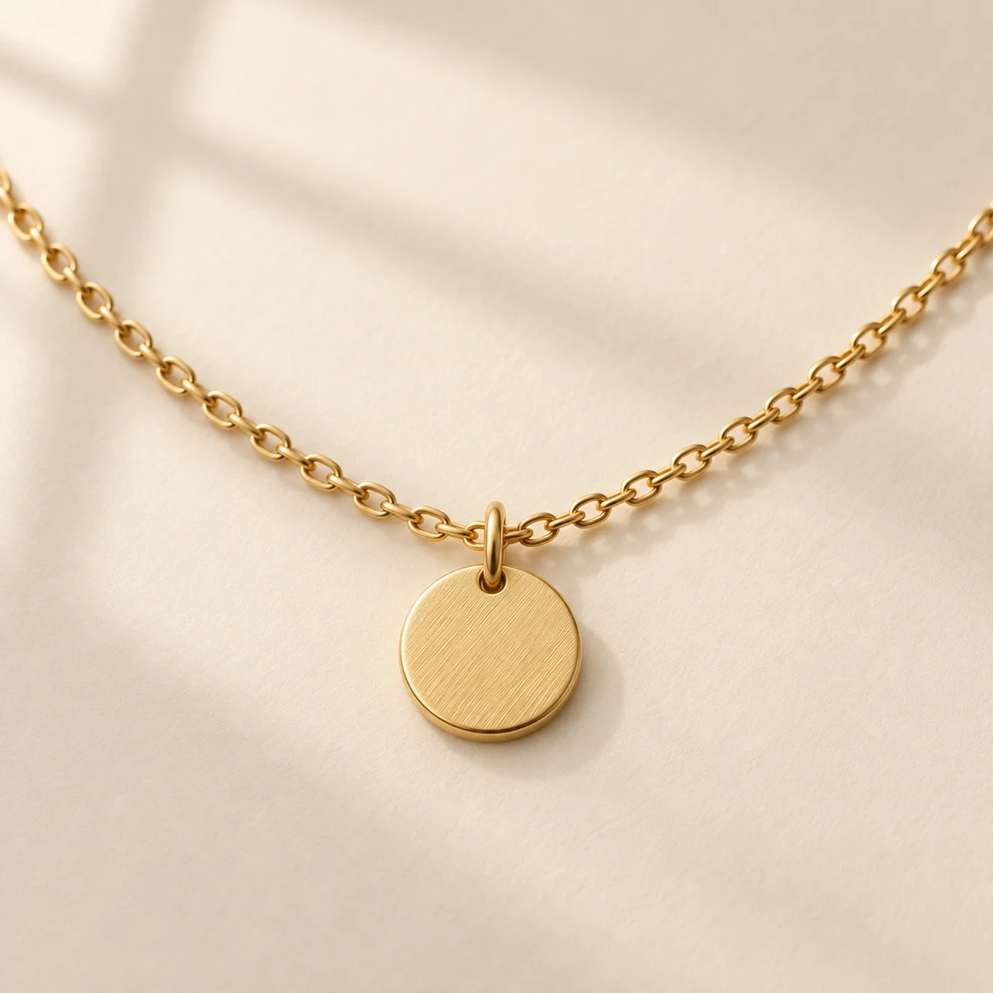 Komorebi Disc Necklace: close-up of the Gold pendant