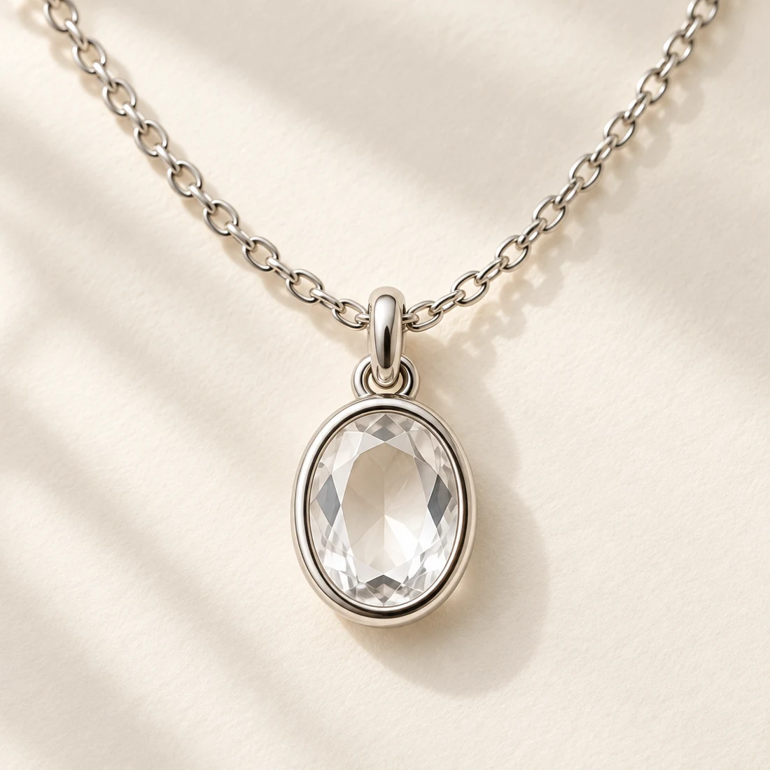 Mizu Oval Necklace: close-up of the Silver / Clear pendant